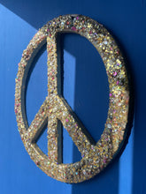 Medium gold glitter, sequin and resin peace sign.