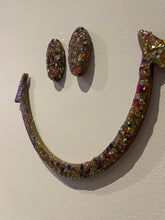 Large gold glitter and sequin eyes and mouth.