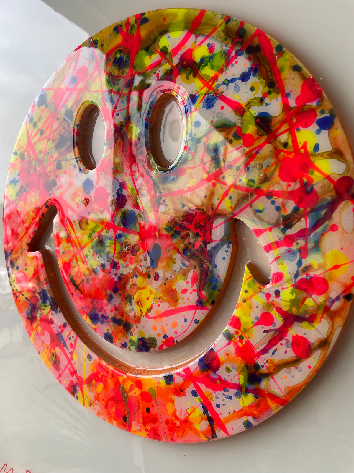Framed resin splatter smiley