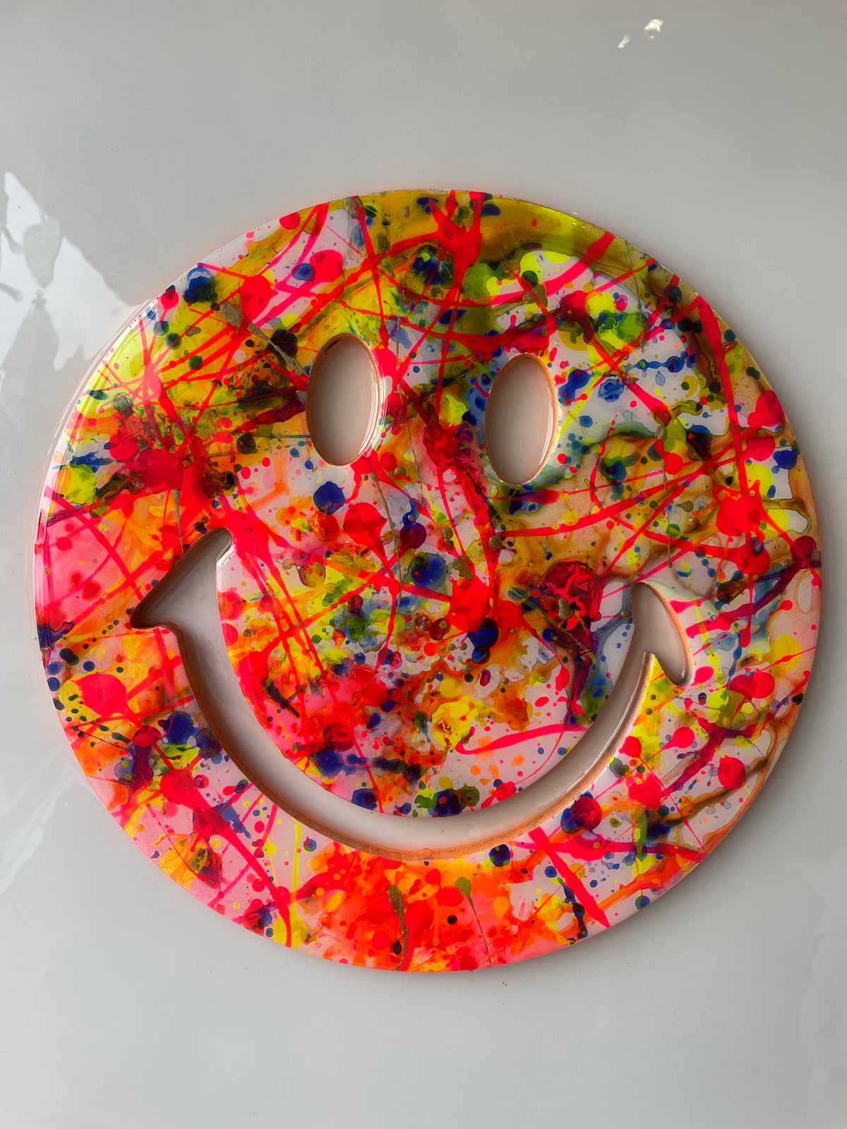 Framed resin splatter smiley