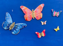 Medium blue and pink quartz crystal and resin butterfly.