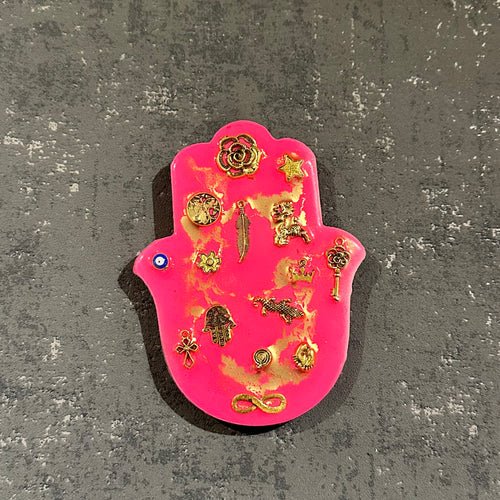 Small neon pink hamsa hand with gold miligros charms.