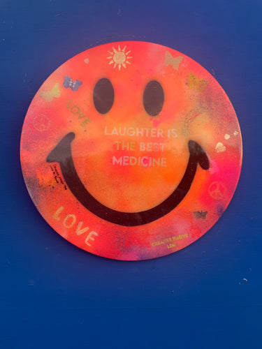 X Large 50 cm laughter is the best medicine orange based smiley. Mixed media and resin.