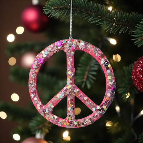 Hot pink resin, sequin and glitter peace sign Christmas decoration.